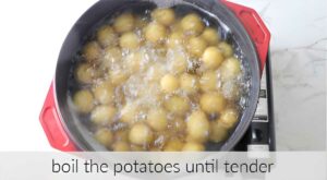 Boiling a pot of creamer potatoes with skin on.