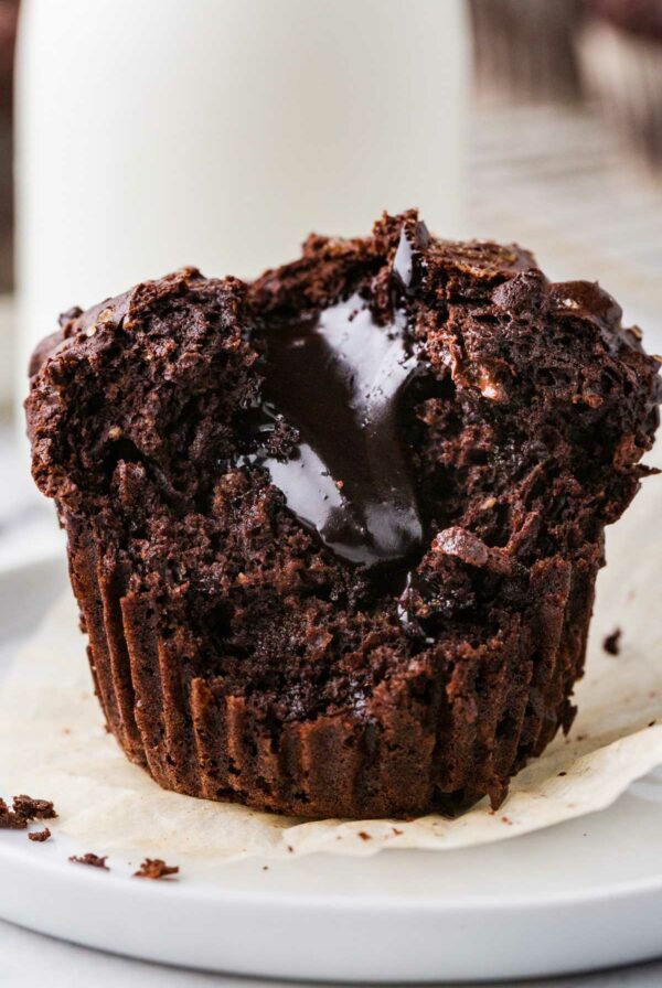 A chocolate volcano muffins with fudge filling on a plate.