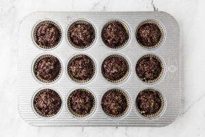 A muffin tip filled with nyt chocolate muffins, ready for the oven.