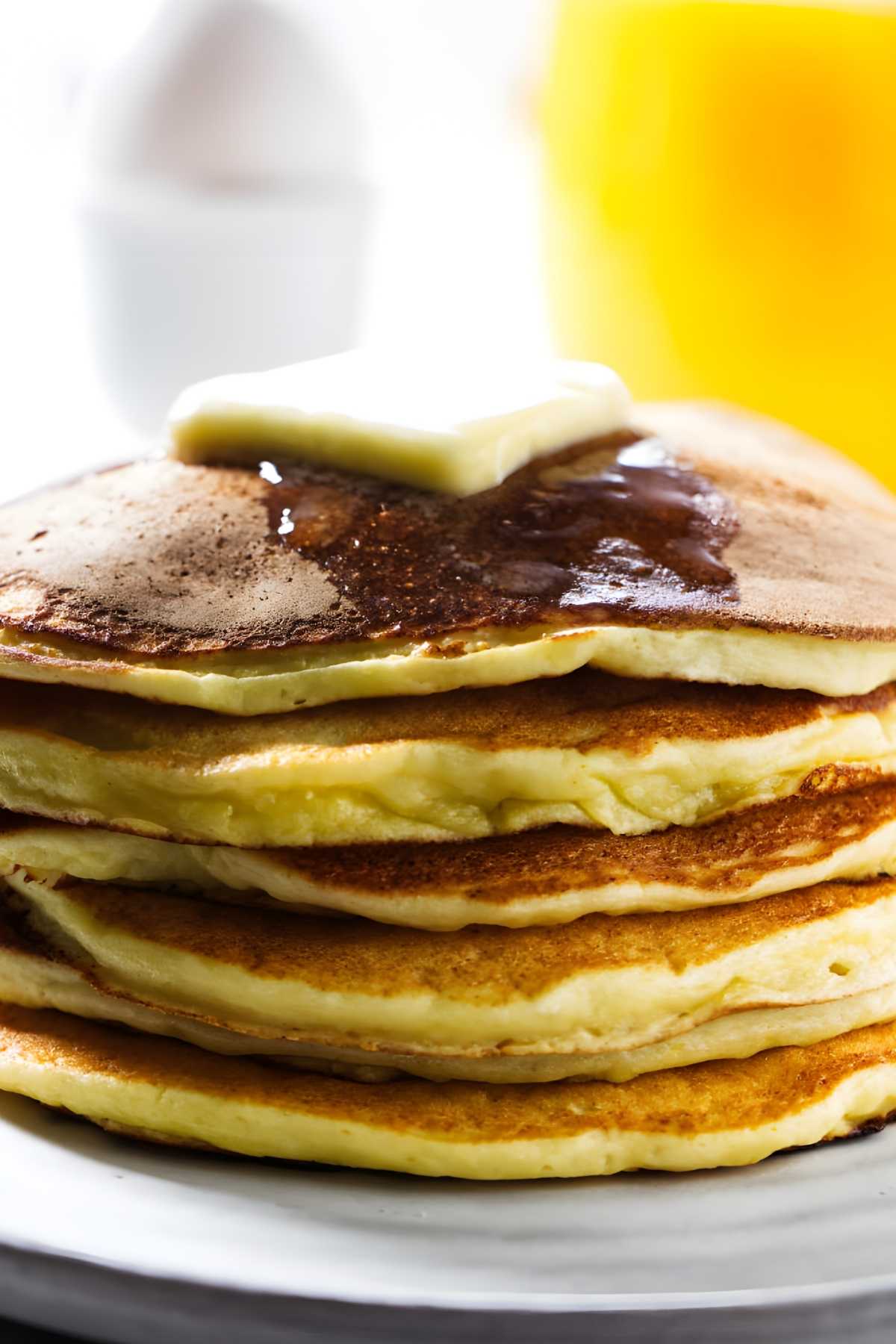 Butter melting on top of orange creamsicle pancakes.