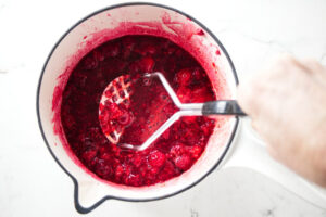 Cooking raspberries with sugar.
