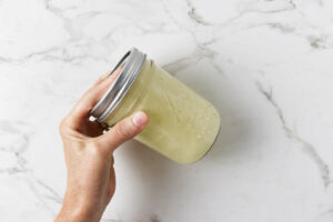 Shaking vinaigrette int a mason jar.