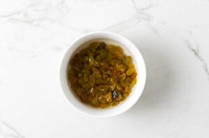 Soaking raisins in a bowl of water.