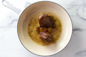 Searing beef tenderloin for a cast iron steak recipe.