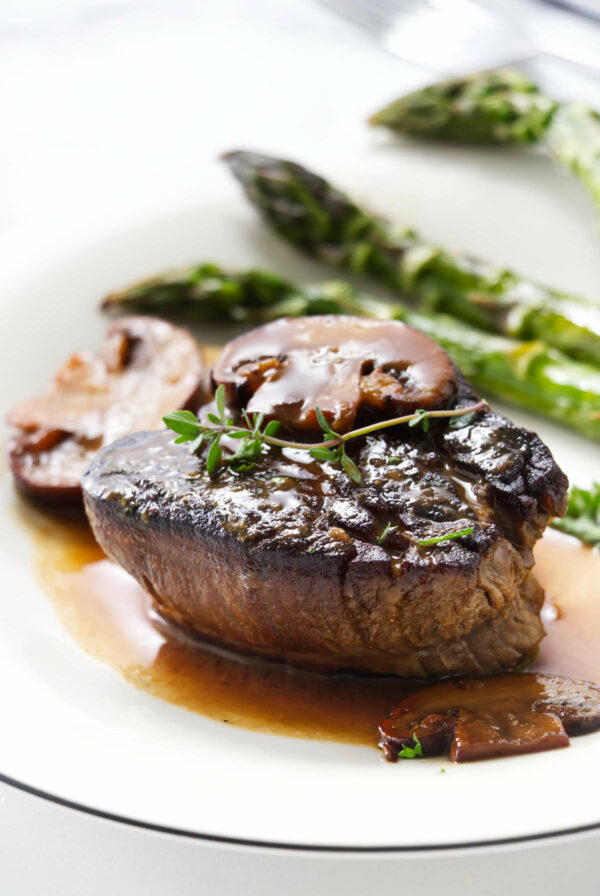 A classic steak diane beef tenderloin with Worcestershire cream sauce on a plate.