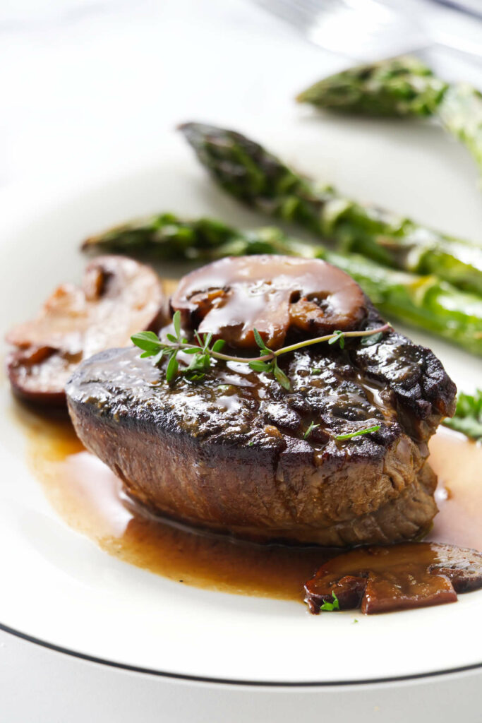A classic steak diane beef tenderloin with Worcestershire cream sauce on a plate.