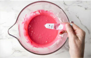 Adding food coloring to cake batter.