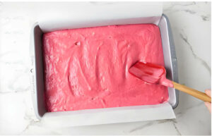 Spreading cake batter in a pan.