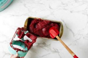Spreading sorbet in a pan to transfer to the freezer.