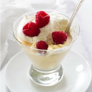 A dessert cup filled with homemade vanilla pudding cooked on the stovetop.