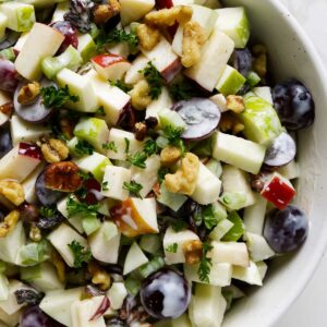 A salad bowl filled with a classic waldorf salad.