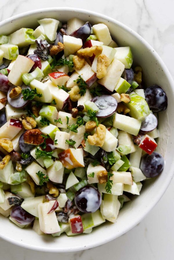 A salad bowl filled with a classic waldorf salad.