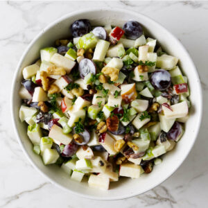 A large bowl filled with waldorf salad.