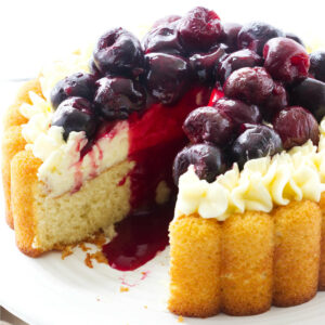 A sponge cake with mousseline cream and topped with cherry compote.