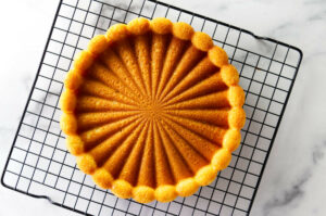 Cooling an almond cream sponge cake on a rack.