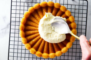Spreading mousseline cream on a sponge cake.