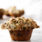 Close-up of chocolate chip muffin with streusel topping.
