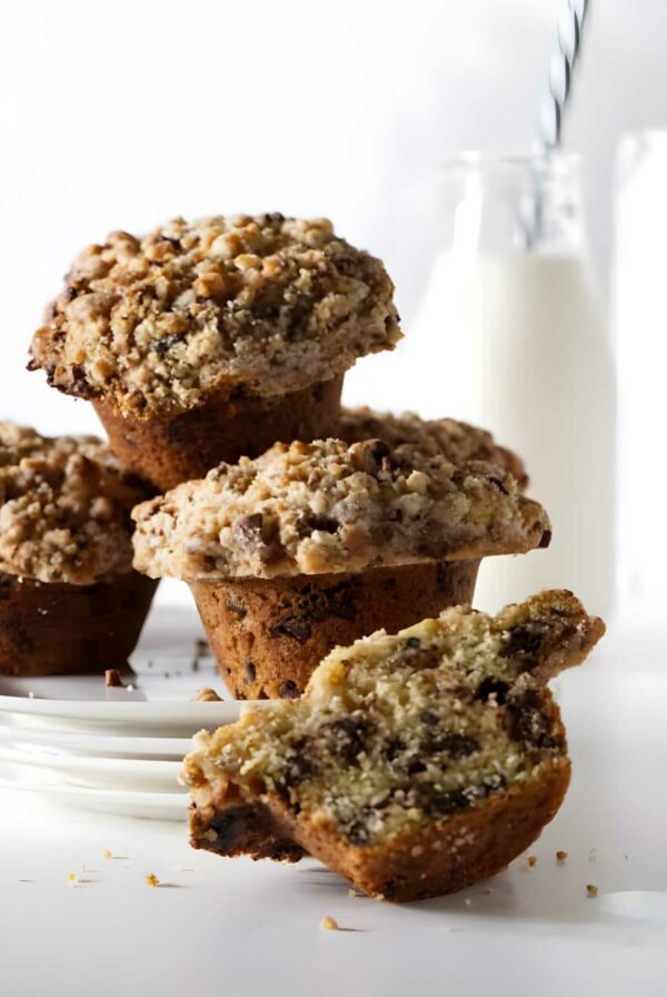 Close-up of crumbly chocolate chip muffins, one halved.