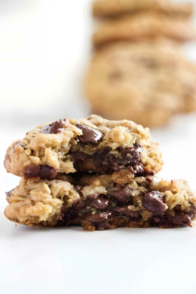 Stacked oatmeal chocolate chip cookies with gooey melted chocolate.