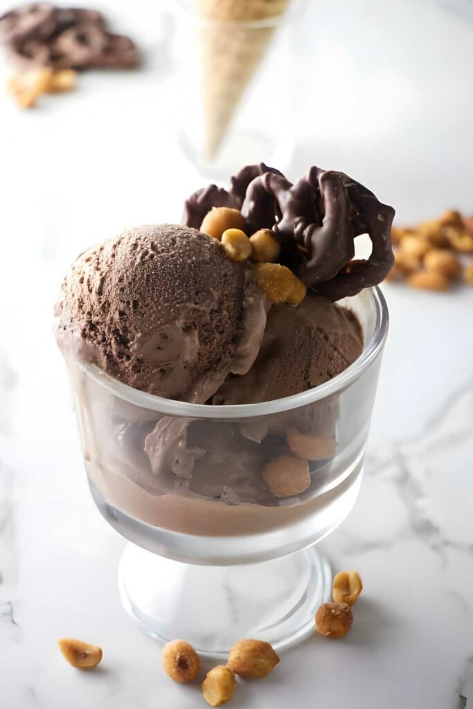 chocolate stout ice cream Chocolate stout ice cream with chocolate pretzels and peanuts in a glass dish.