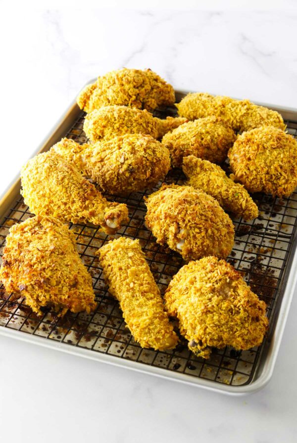 Corn flakes coated chicken on a baking sheet.