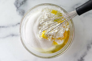 Whisking sugar, egg and cornstarch in a mixing bowl.