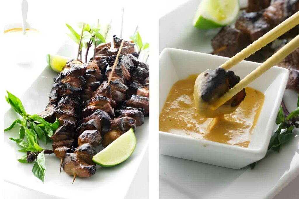 Grilled meat skewer s dipped in peanut sauce, basil and lime garnish.