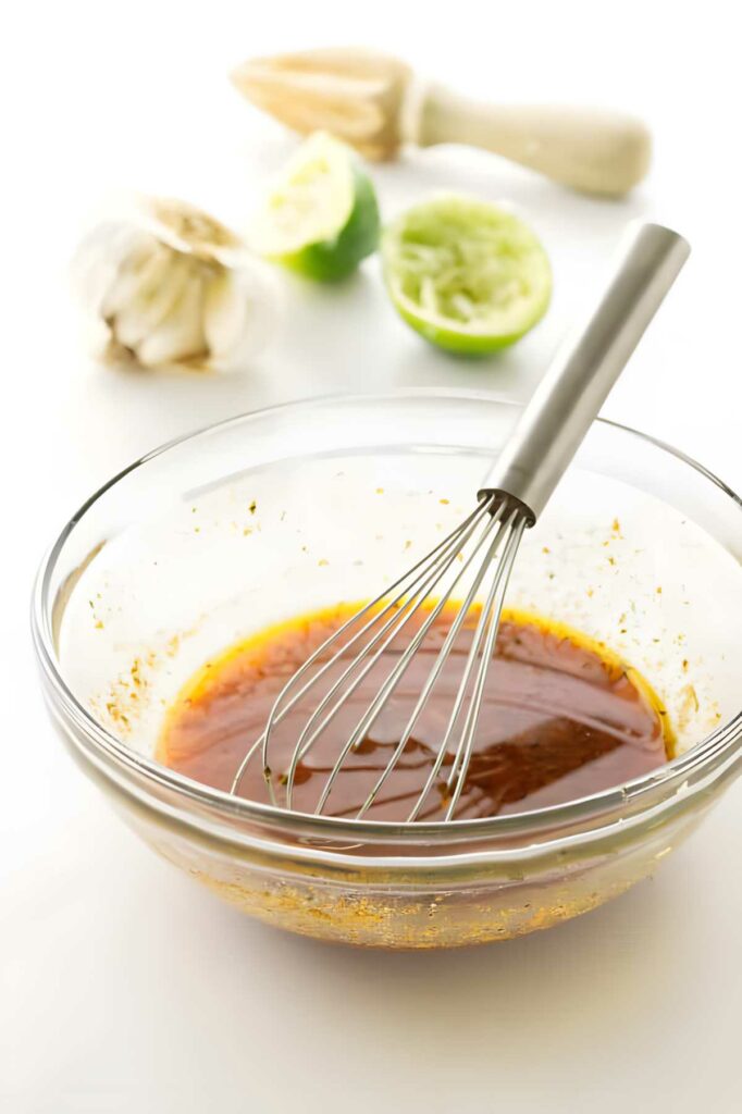 A bowl of marinade for chicken fajitas.