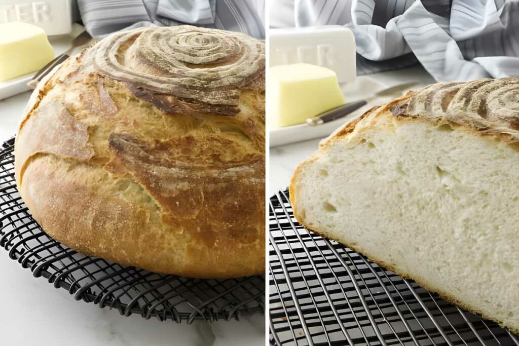 Round crusty bread loaf, sliced to show airy crumb, with butter nearby.