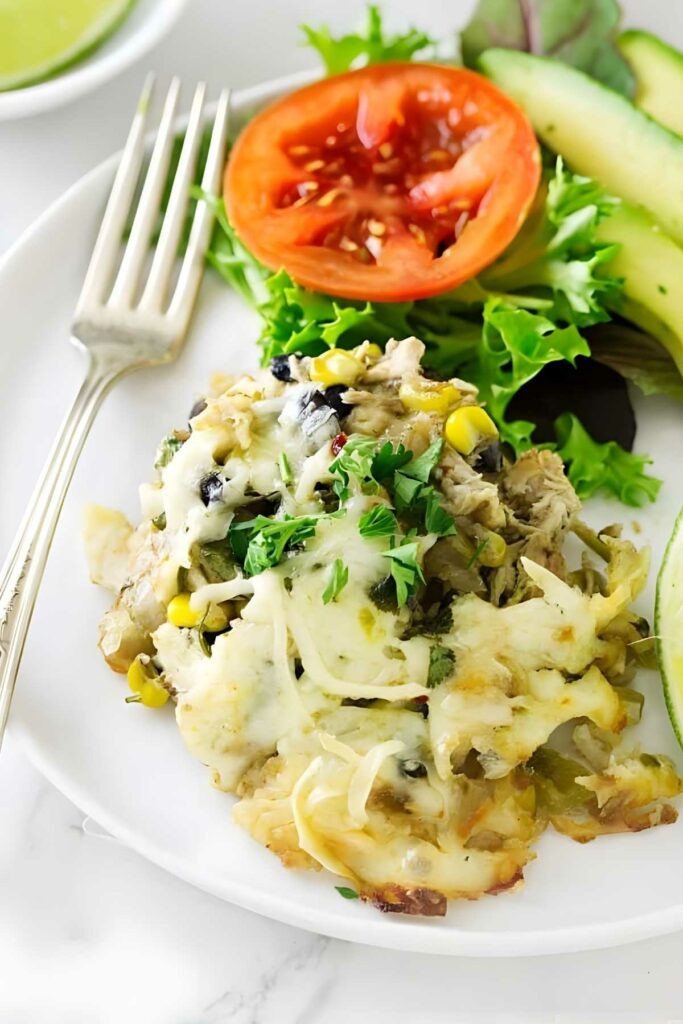 Cheesy casserole with corn, herbs, fresh greens, avocado, and tomato.