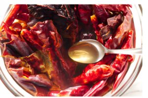 Soaking dried chile peppers.