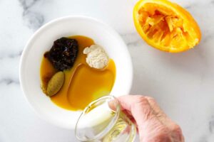 Mixing a glaze in a bowl.