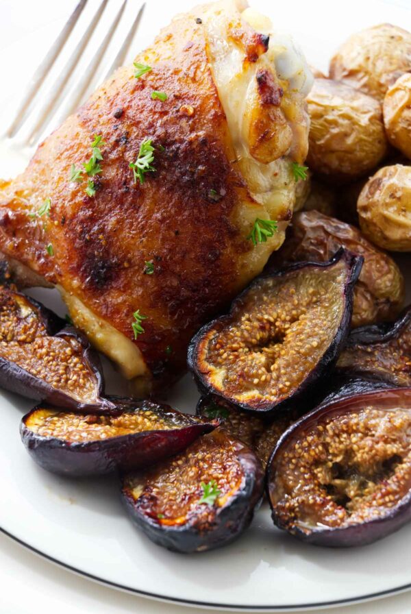 A serving of chicken thighs with roasted figs.
