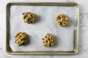 Baking bakery style chocolate chip cookies on a cookie sheet.