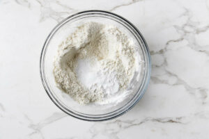Blending dry ingredients in a mixing bowl.