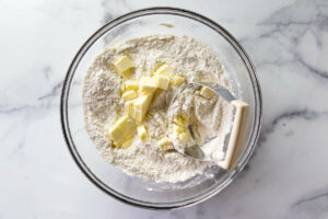 Blending cold butter into flour mixture.