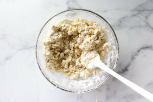 Stirring buttermilk into the biscuit batter.