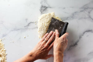 Folding biscuit dough to create flaky layers.