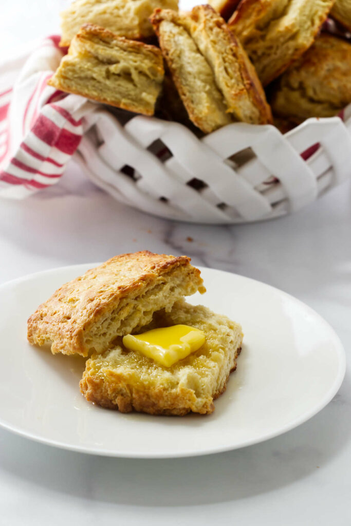 A buttermilk biscuit with a pat of butter on top.