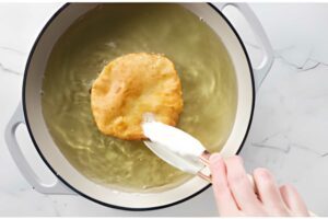 Frying flatbread in hot oil.