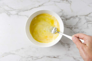 Whisking eggs in a bowl.