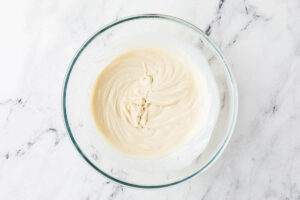 A mixing bowl with white batter.