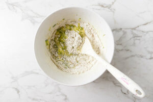 Folding the dry ingredients into muffin batter.