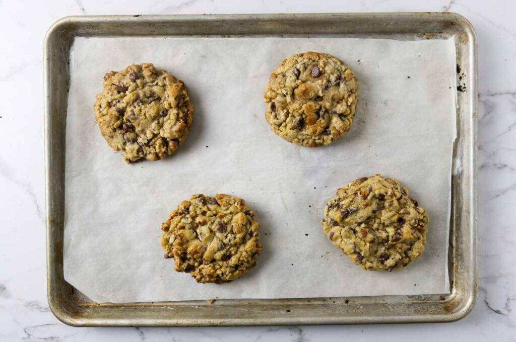 Warm New York bakery cookies on a sheet pan.