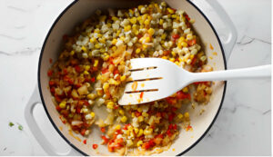 Stirring enchilada mixture in a skillet.