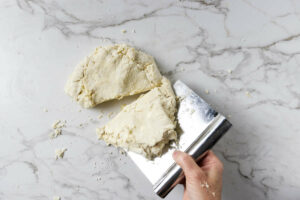 Stacking the dough to give it laminated layers.