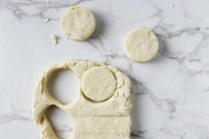 Cutting the dough into round biscuits.
