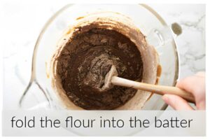 Folding dry ingredients into brownie batter.