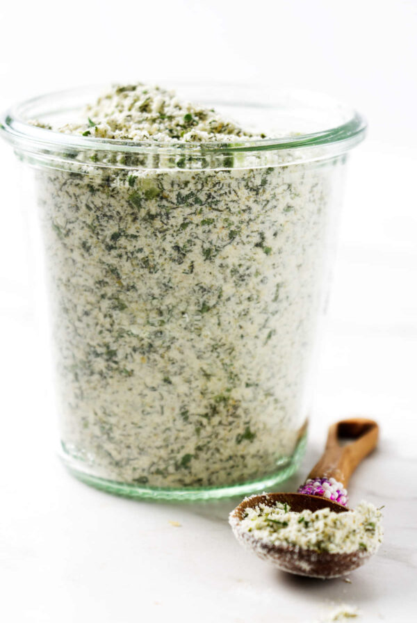 A jar of diy ranch powder seasoning blend next to a spoon.