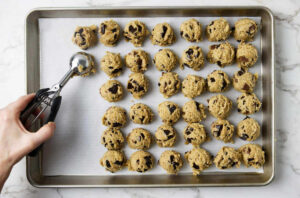 Placing cookie dough on a tray to chill in the fridge.